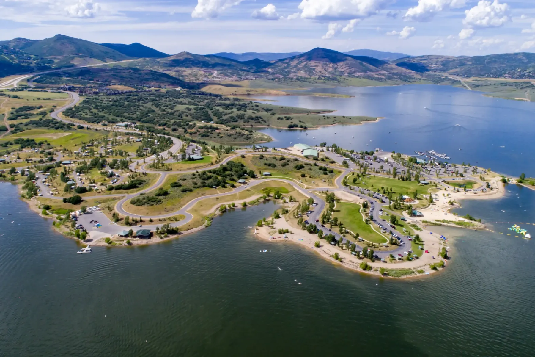 An aerial view of Jordanelle Reservoir, shoreline recreation areas and surrounding hills