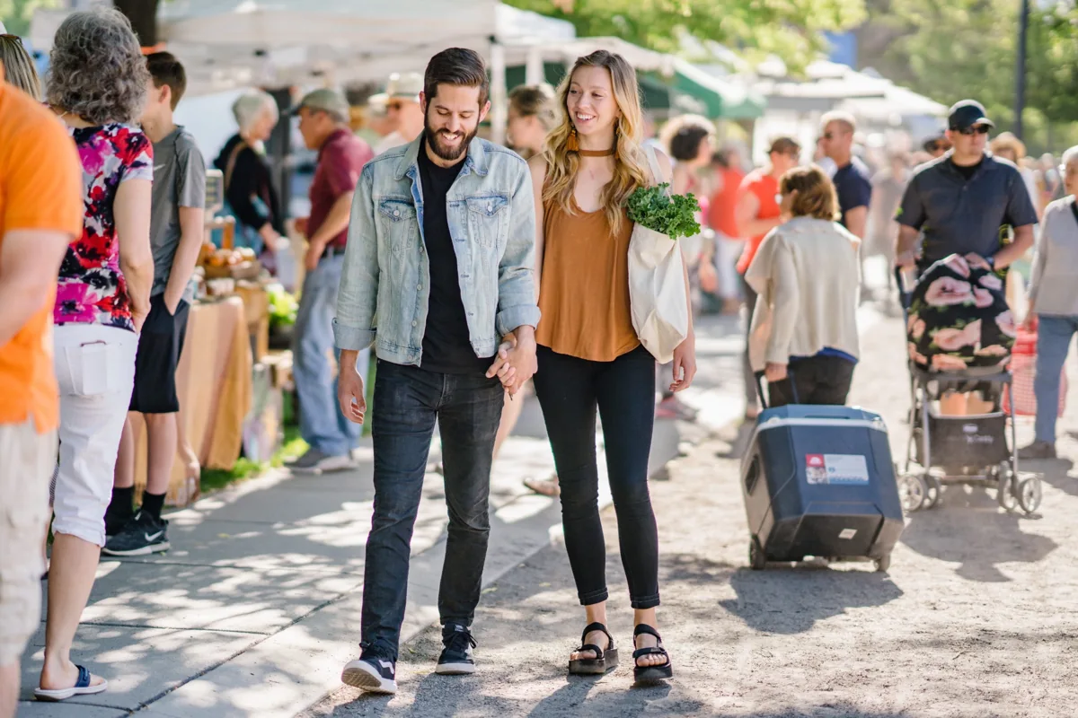 Shoppers walking between stalls at the Downtown Farmers Market
