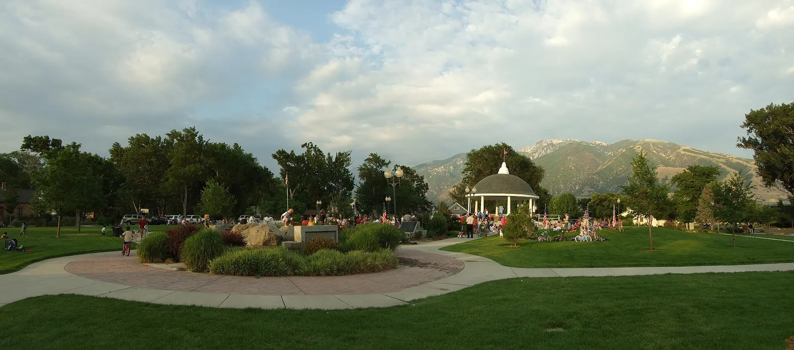 Paths, lawn and a gazebo at Draper Historic Park with mountains behind