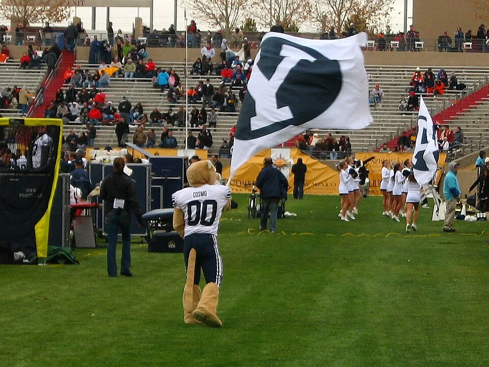Cosmo the Cougar waving a BYU flag after a touchdown