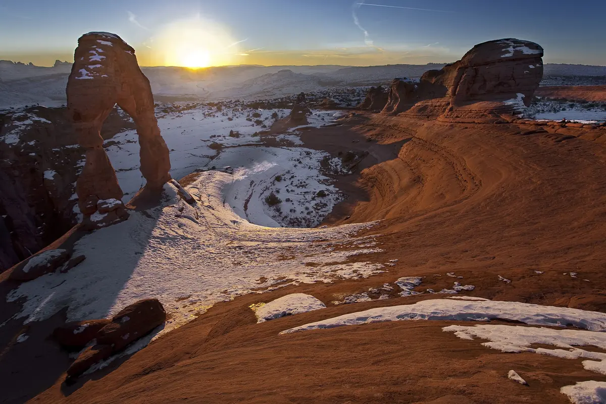 Delicate Arch at sunrise with snow on the slickrock, Arches National Park