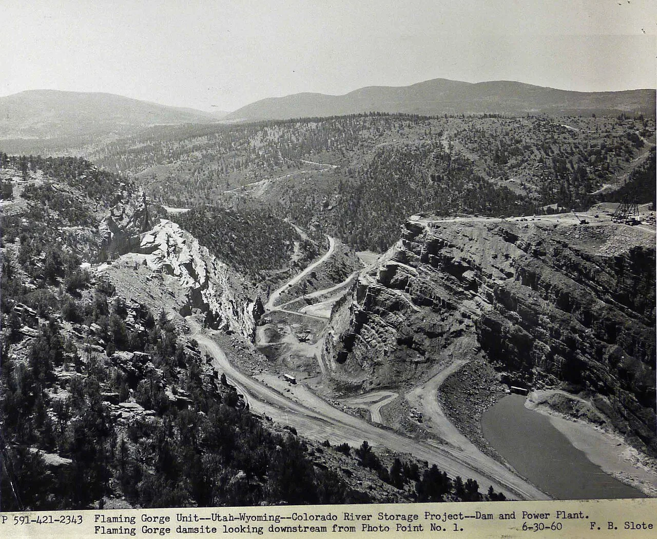 Downstream view of the Flaming Gorge Dam site in 1960, with the Green River diverted through a tunnel and coffer dams in place
