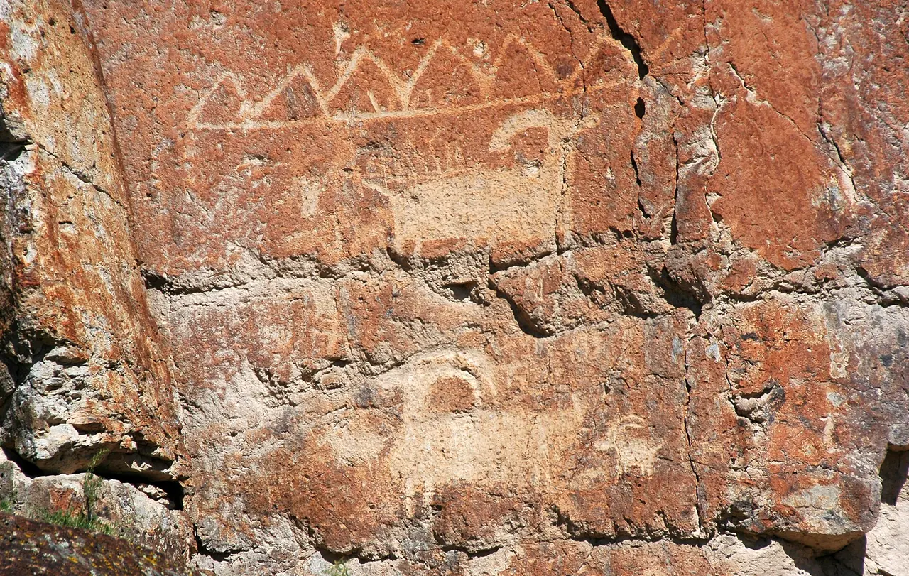 Ancient Fremont petroglyphs pecked into a rock face at Fremont Indian State Park