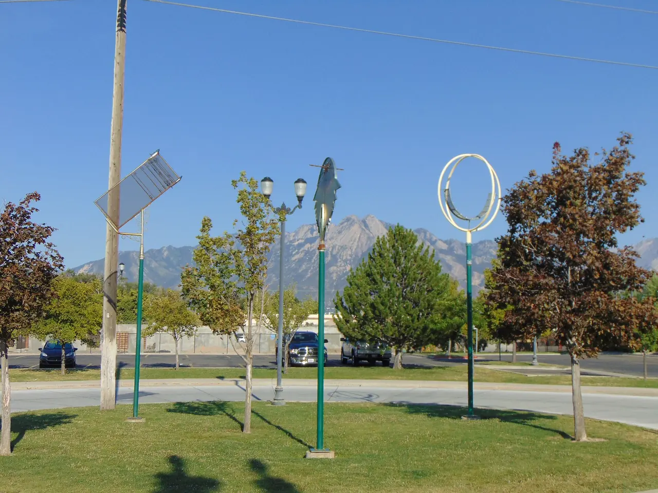 Public art at the Murray North TRAX station with mountains behind