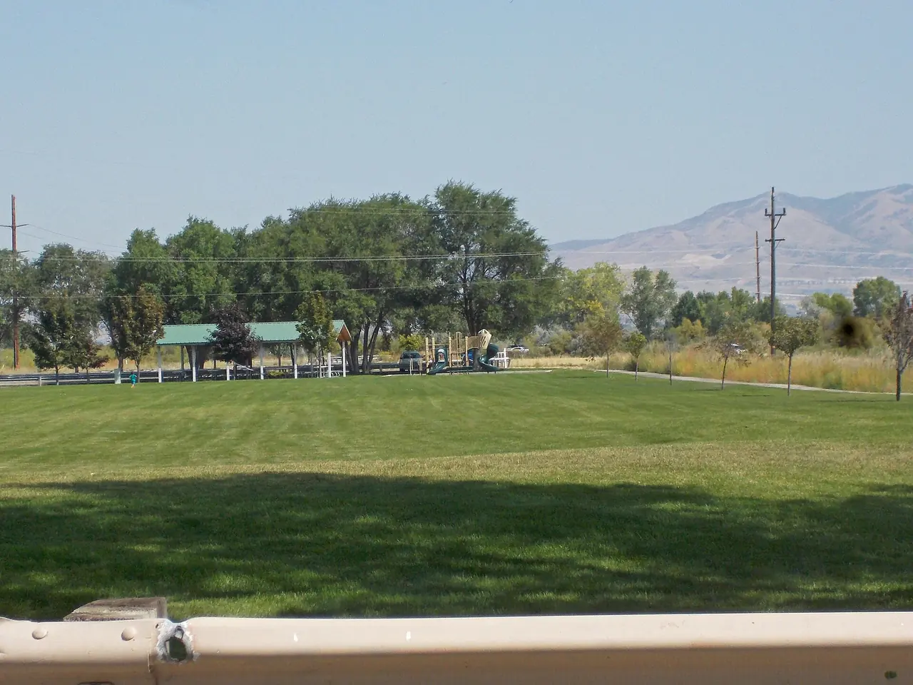 A grassy park with a picnic pavilion in Saratoga Springs