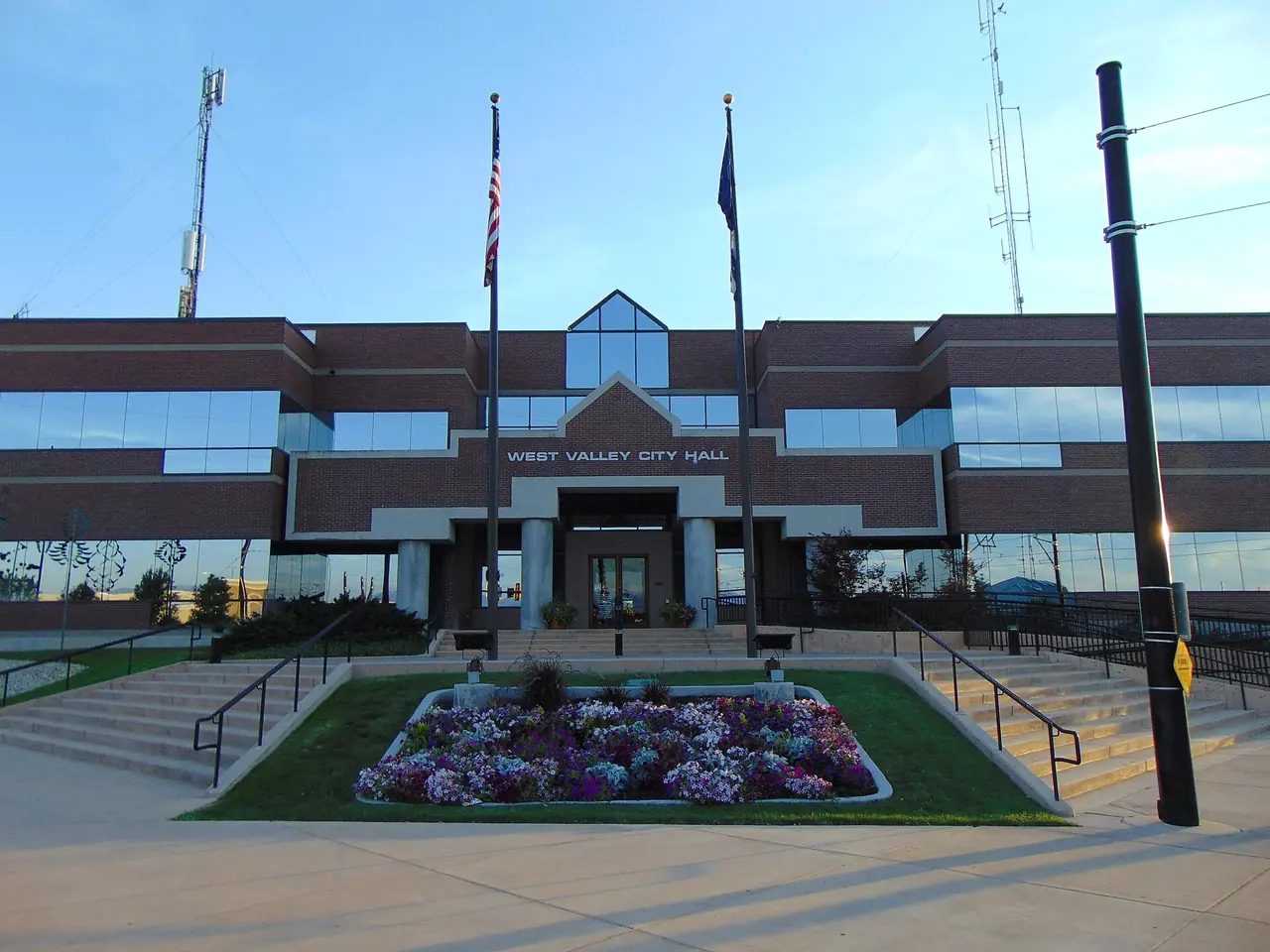 West Valley City Hall with flower beds and flagpoles out front
